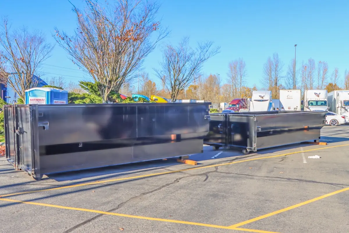 Professional dumpster rental service with roll-off container on residential driveway in Guthrie